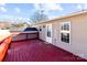 Red deck with railing and access to house at 700 Leonard Ave, Kannapolis, NC 28081