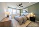 Modern bedroom featuring a ceiling fan, large windows, and stylish decor at 8018 Elevate Ct, Charlotte, NC 28205