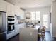 Modern kitchen with white cabinets, stainless steel appliances, and an island at 8018 Elevate Ct, Charlotte, NC 28205