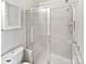 Bathroom with shower stall and white tiled walls at 8035 Bristle Ln, Charlotte, NC 28214