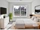 Virtually staged bedroom with large window and modern dresser at 8035 Bristle Ln, Charlotte, NC 28214