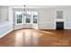 Bright dining room features hardwood floors, a fireplace, and a bay window at 8035 Bristle Ln, Charlotte, NC 28214