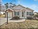 Brick and siding ranch home with attached garage and landscaped yard at 8035 Bristle Ln, Charlotte, NC 28214
