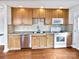 Kitchen with wood cabinets, granite counters, and stainless steel appliances at 8035 Bristle Ln, Charlotte, NC 28214