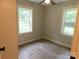 Bright bedroom with two windows and wood-look floors at 806 Marve St, Gastonia, NC 28052