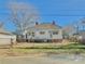 Back view of a home with a detached garage, surrounded by a chain-link fence at 85 5Th St, Cramerton, NC 28032