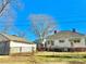 Back view of a home with a detached garage, surrounded by a chain-link fence at 85 5Th St, Cramerton, NC 28032
