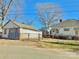Rear view of a home with a detached garage, surrounded by a chain-link fence at 85 5Th St, Cramerton, NC 28032