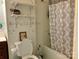 Cozy bathroom featuring a shower-tub combo, toilet, and shelving for linens at 85 5Th St, Cramerton, NC 28032