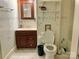 Bathroom featuring tiled floors, dark wood cabinets, and open-seat toilet at 85 5Th St, Cramerton, NC 28032