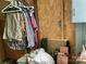 An untidy walk-in closet with clothes hanging and assorted storage items at 85 5Th St, Cramerton, NC 28032