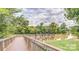 Picturesque view of a pond from a wooden walkway with seating areas at 85 5Th St, Cramerton, NC 28032