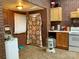 Cozy kitchen with brick walls, wooden cabinets, and updated appliances at 85 5Th St, Cramerton, NC 28032