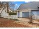 Enclosed backyard featuring a charming pergola, white picket fence, and rear home entrance at 111 Wheaton Ct, Salisbury, NC 28147