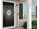 Front entrance with black door, welcome sign, and lantern light at 11627 Tribal Dr, Charlotte, NC 28214
