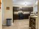 Dark brown cabinets, kitchen island, and stainless steel appliances at 11627 Tribal Dr, Charlotte, NC 28214