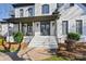 Two-story white brick home with dark gray trim, a large front porch, and a stone walkway at 11917 James Jack Ln, Charlotte, NC 28277