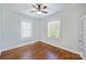 Simple bedroom with hardwood floors and ceiling fan at 1204 Buchanan St, Charlotte, NC 28203