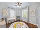 Virtually staged bedroom with hardwood floors and ceiling fan at 1204 Buchanan St, Charlotte, NC 28203