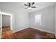 Bedroom with hardwood floors, ceiling fan, and access to bathroom at 1204 Buchanan St, Charlotte, NC 28203