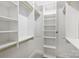 Large walk-in closet with built-in shelves and rods at 1204 Buchanan St, Charlotte, NC 28203