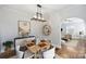 Dining room with hardwood floors, staged table setting, and view of living room at 1204 Buchanan St, Charlotte, NC 28203