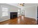 Spacious living room with hardwood floors, fireplace, and large windows at 1204 Buchanan St, Charlotte, NC 28203
