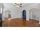 Living room with hardwood floors, built-in shelving, and views into the kitchen at 1204 Buchanan St, Charlotte, NC 28203
