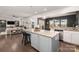 Open concept kitchen with island and granite countertops, overlooking living room at 1216 Longwall Ln, Matthews, NC 28105