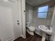Clean bathroom with white sink, toilet, and bathtub at 1300 Brookdale St, Kannapolis, NC 28083