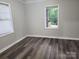 Bright bedroom with neutral walls, wood floors, and window with blinds at 1300 Brookdale St, Kannapolis, NC 28083