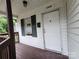 Front door entrance with dark brown porch and green shutters at 1300 Brookdale St, Kannapolis, NC 28083