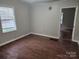 Simple living room with wood floors and neutral walls at 1300 Brookdale St, Kannapolis, NC 28083