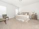 Bright bedroom with carpeted floor and two chairs at 1308 Black Walnut St, Monroe, NC 28112