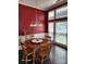 Charming dining room with wood table and chairs, and a red accent wall at 13407 Stephendale Dr, Charlotte, NC 28273