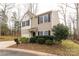 Tan two-story house with a white garage door and landscaping at 1444 Swaying Branch Ln, Clover, SC 29710