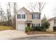Tan two-story house with a white garage door and landscaping at 1444 Swaying Branch Ln, Clover, SC 29710
