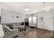 Spacious living room with gray sectional sofa and wood floors at 1444 Swaying Branch Ln, Clover, SC 29710