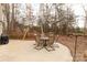 Concrete patio with table and chairs, nestled in a wooded setting at 1444 Swaying Branch Ln, Clover, SC 29710