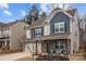 Two-story house with gray and blue siding, stone accents, and a covered porch at 203 Abersham Dr, Mooresville, NC 28115