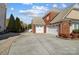 Spacious three-car garage with an extended driveway and manicured landscaping at 2607 Catesby Dr, Waxhaw, NC 28173