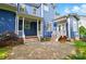 Exterior view of the blue home showcasing a back porch and well-maintained yard at 2607 White Pines Ct, Monroe, NC 28112