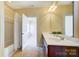 A view of a bathroom showcasing a double vanity, bathtub, and shower with a white shower curtain at 2607 White Pines Ct, Monroe, NC 28112