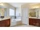 Bathroom featuring a corner soaking tub and double vanity at 2607 White Pines Ct, Monroe, NC 28112