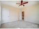 An empty bedroom featuring neutral paint, trim, carpet, and a doorway to an upstairs hallway at 2607 White Pines Ct, Monroe, NC 28112