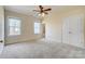 A spacious bedroom with neutral paint, carpet, windows, and a double-door closet at 2607 White Pines Ct, Monroe, NC 28112
