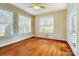 Bright bedroom with hardwood floors, a ceiling fan, and multiple windows at 2607 White Pines Ct, Monroe, NC 28112