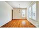 Bright dining room with hardwood floors, chandelier, large windows, and detailed trim at 2607 White Pines Ct, Monroe, NC 28112