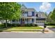 Charming blue two-story home with a welcoming front porch and well-maintained landscaping at 2607 White Pines Ct, Monroe, NC 28112
