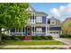 Charming blue two-story home with a welcoming front porch and well-maintained landscaping at 2607 White Pines Ct, Monroe, NC 28112